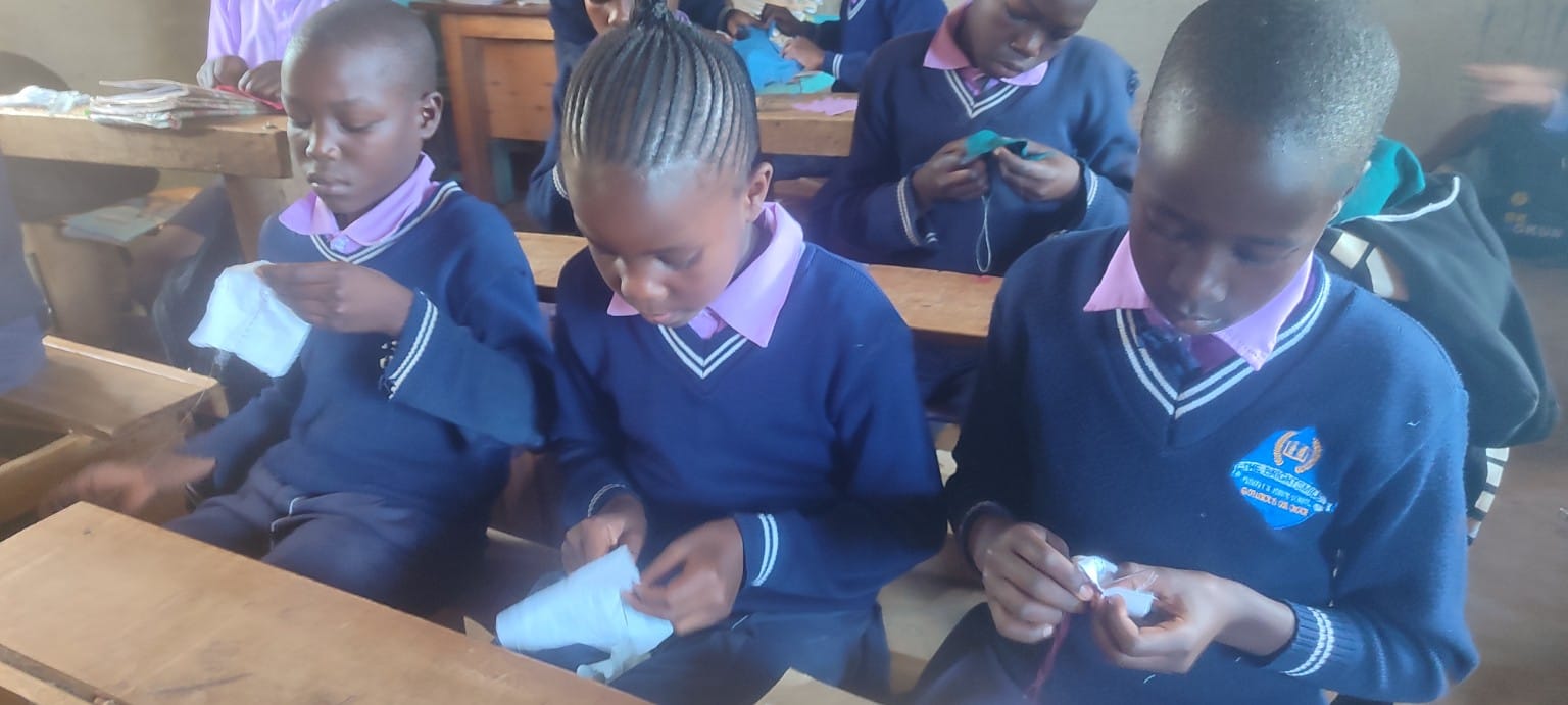 Junior school learners practising needlework during a pre-technical studies lesson
